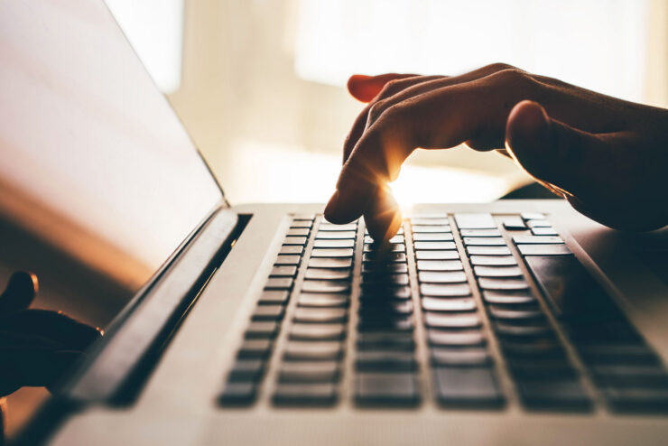 A person's hand on a computer keyboard