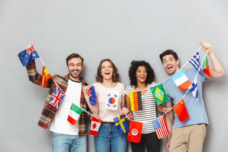 Four persons are holding flags