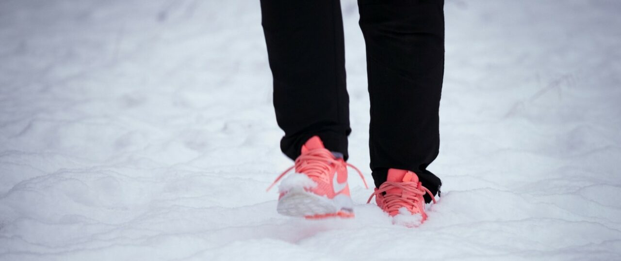 A person's feet on the snow.