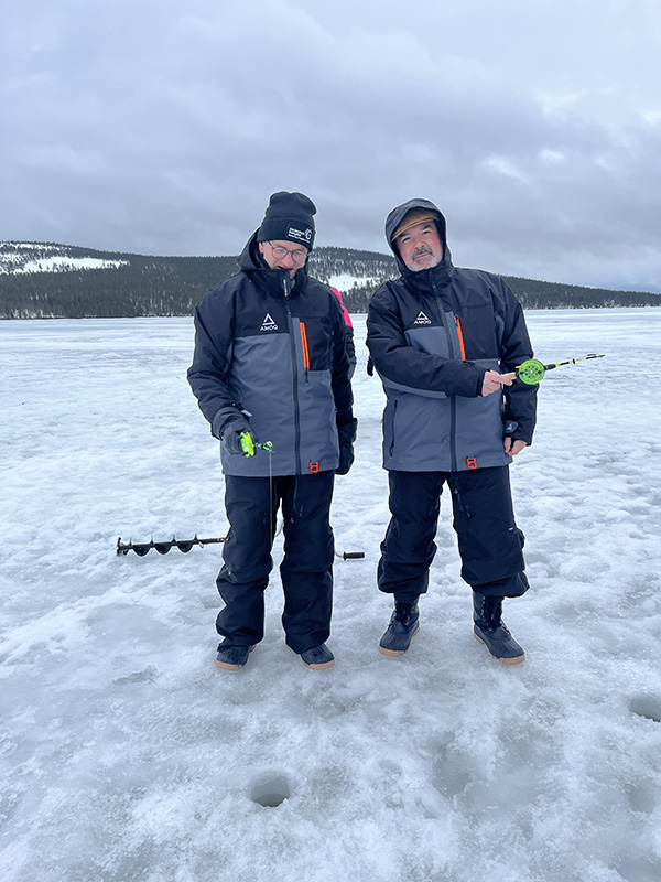 Men trying ice fishing