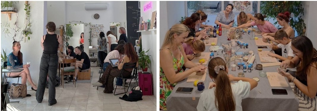 Figure 9. A photograph shows several people gathered in a bright indoor space with white walls and plants. Some individuals sit at tables working on laptops or talking, while others stand or move around this collaborative and workshop-like environment. Figure 10. A photograph shows a group of people seated around a large table engaged in a hands-on activity. The table is covered with materials such as clay, tools, brushes, and small containers, while participants shape objects and work with their hands in a collaborative workshop setting.